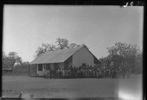 African people standing in front of the chapel, Mahele, Mozambique, 1946