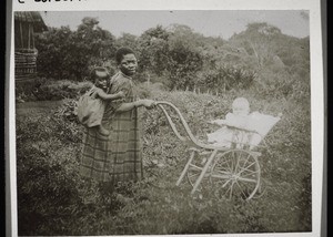 A children's nurse with a black and a white child