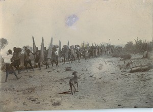 Carrying bundle of sticks for covering the Lukona church's roof