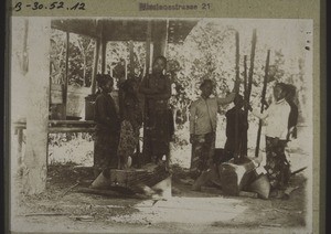 Dajak girls pounding rice in Pangelak