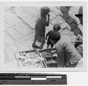 A woman selling goods at Kunming, China, 1947