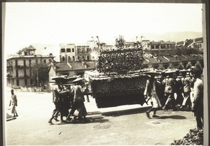 Chinese funeral in Kowloon. Photograph by Rev. Weickum, Fopin. The coffin is carried by 16 men