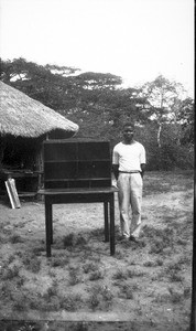 African apprentice with a piece of furniture he made, Ricatla, Mozambique