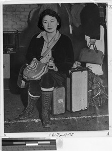 Woman evacuee sitting on luggage, Los Angeles, California, June 1942