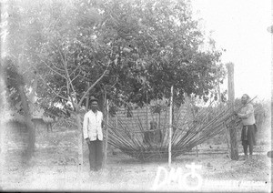 African men constructing the roof of a hut, Antioka, Mozambique, ca. 1896-1911