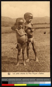 Two emaciated children standing on a plain, South Africa, ca.1920-1940