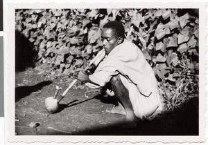 Dilgaasaa's son smoking a water pipe, Guduru Gute, Ethiopia, ca.1952-1953