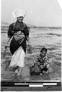 Mother and son clam fishing, Tokyo, Japan, August 1932