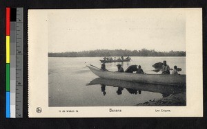 Missionary father sitting in beached boat, Congo, ca.1920-1940