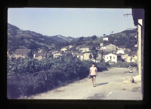 boy walking along a village street