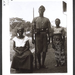 West African soldier in the service of the German Government in Buea, with his wife and his servant