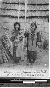 Ainu man and woman standing outside, Japan, ca. 1920-1940