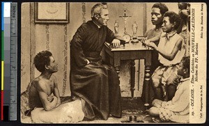 Missionary father at a desk with young indigenous students, New Caledonia, ca.1900-1930