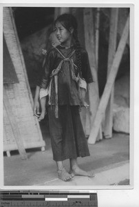 A girl cares for a baby in China, 1936