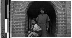 Maryknoll Sister M. Dolarine standing with children, Gishu, Korea, 1930