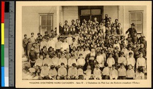 Bishop seated among orphans outside an orphanage, Canada, ca.1920-1940