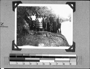 People posing with a shot crocodile, Ipanya, Tanzania, 1937