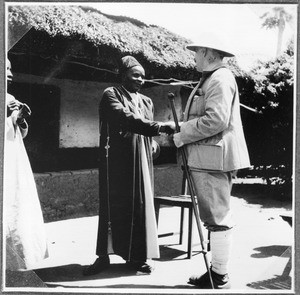 Missionary Guth bidding good-bye to chief Kigono, Gonja, Tanzania, 1938