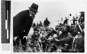 Missioner talking to a group of people, Africa, 1940