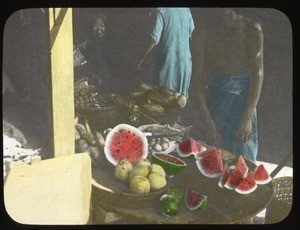 Merchant and slices of watermelon on a market table, China, ca.1917-1923