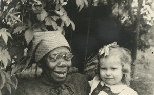 Child of missionaries with her nurse, in Gabon