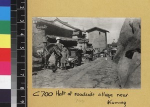 Missionary travelling through village, Yunnan, China. ca. 1920