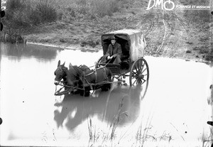 Mr Dawson crossing a river, Valdezia, South Africa, ca. 1896-1911