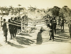 Natives Carrying Log