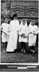 Sister Patricia Marie Callan, MM, with three first communicants, Malabon, Philippines, ca. 1920-1940