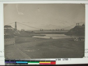 Four buses crossing the suspension bridge over Sisaony River at Nosizato, Antananarivo, Madagascar, ca.1905