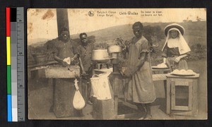 People making butter outdoors, Congo, ca.1925