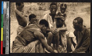 Men and children playing a game, Kakyelo, Congo, ca.1920-1940