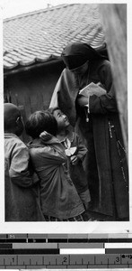 Sister Talitha, MM, with three kindergarten children, Heijo, Korea, June 25, 1939