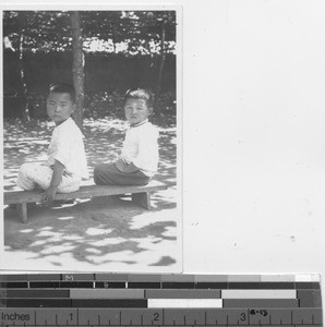 Two small boys at the park at Chiaotou, China, 1935