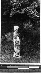 Girl carrying a basket on her back, Japan, ca. 1920-1940