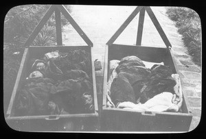 Chinese babies lying in wooden cradles, China, ca. 1918-1938