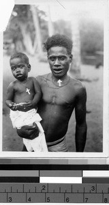 Man holding a child, Africa, 1947