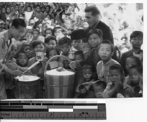 Fr. John Donovan with many refugee children in Meixien, China, 1946