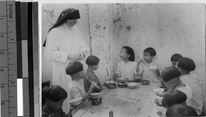 Orphans eating a meal, Yeung Kong, China, ca. 1920