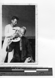 Getting a head shave at Luoding, China, 1937