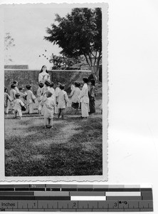 Sister Richards entertains the orphans at Luoding, China, 1937