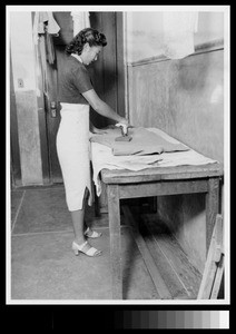 Woman student in the dormitory laundry room at Yenching University, Beijing, China, 1941