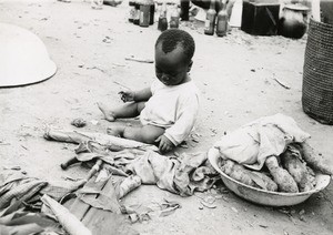 Baby in a market, in Cameroon