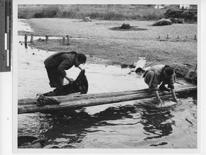 Washing clothes in the river at Wuzhou, China, 1948