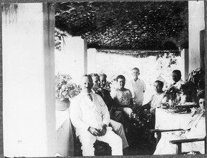 The Blumer family and other persons on a porch, Tanzania, ca. 1925-1930