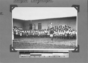 Schoolchildren having morning prayers in front of their school, Rungwe, Tanzania