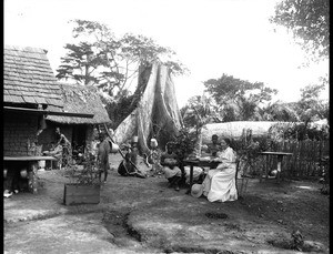 In front of the hut, Mrs Ramseyer and a girl