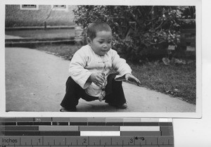A baby playing at Luoding, China, 1935
