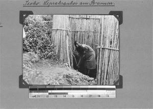 Leper at a well, Isoko, Tanzania, 1929