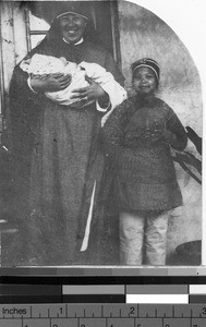Maryknoll Sister holding baby orphan, Loting, China, ca. 1930
